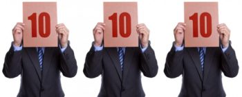 Perfect Score Three men in suites each holding up the number 10 indicating a perfect 10 score