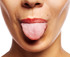 Woman sticking out tongue performing mouthpiece test