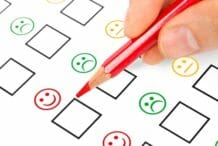 Customer survey showing pencil and satisfaction rating from happy to sad