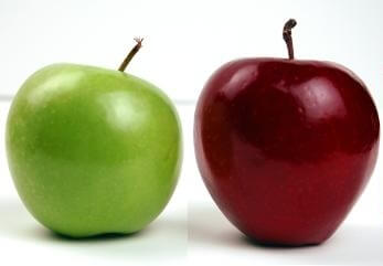 Green apple next to red apple comparing the two 