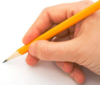 Hand holding pencil writing a review