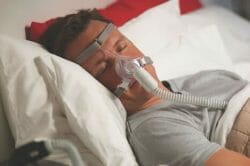 Man wearing CPAP mask sleeping 